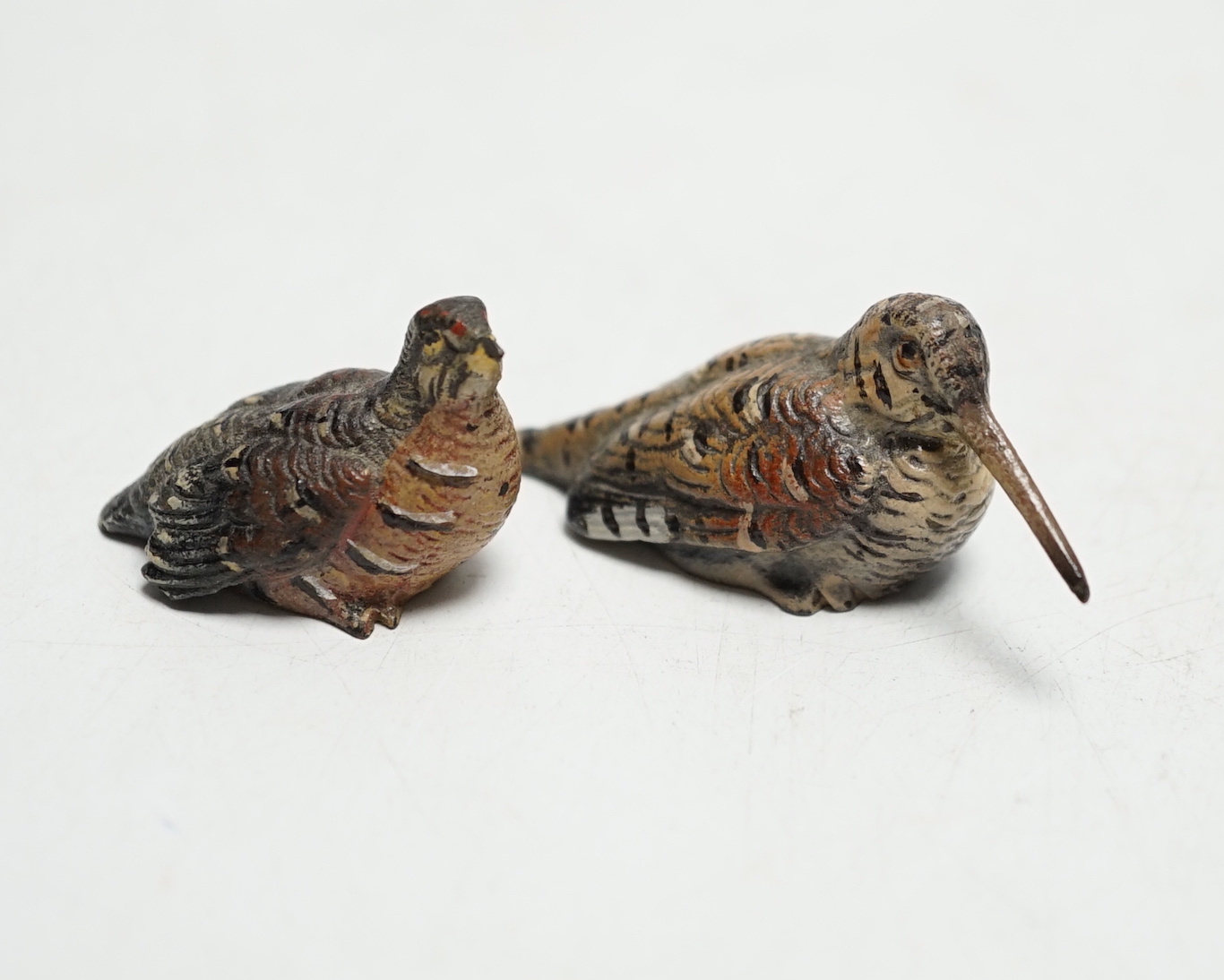 Two miniature Austrian cold painted bronze models of a snipe and partridge, longest 5cm